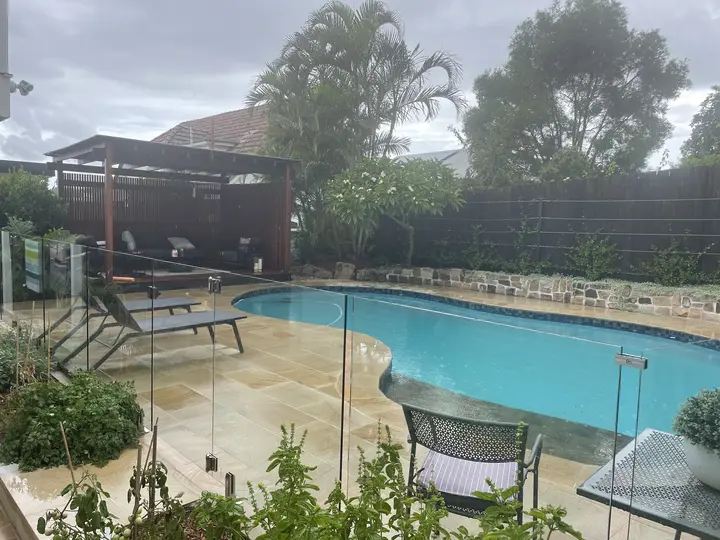 Natural stone paving using granite, glass pool fencing, wood cabana what else do you need